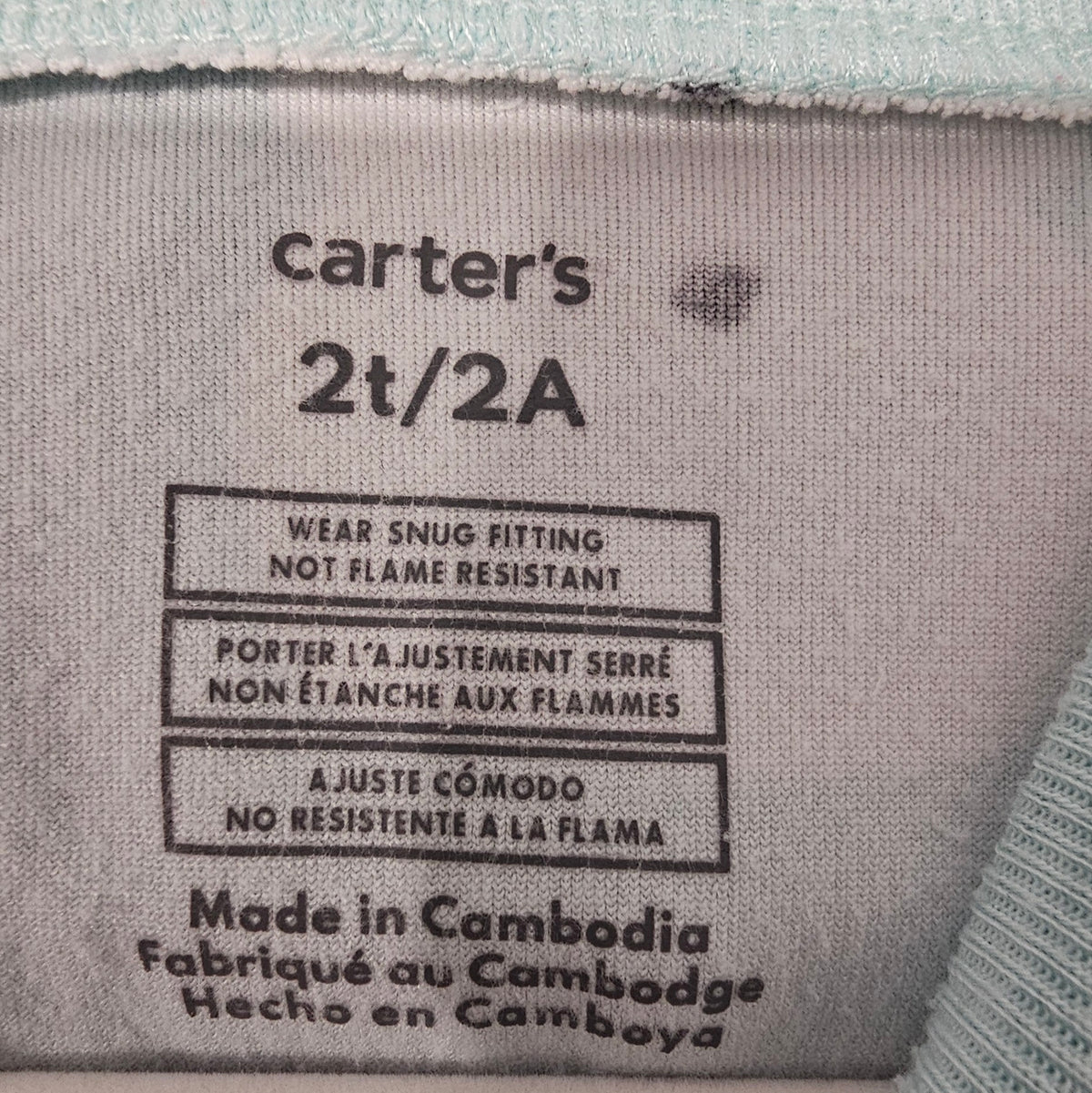 Carter's size 2T label with snug-fitting care information