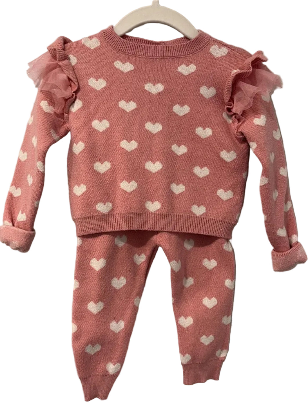 Pink heart-print sweater and matching pants with ruffled shoulders