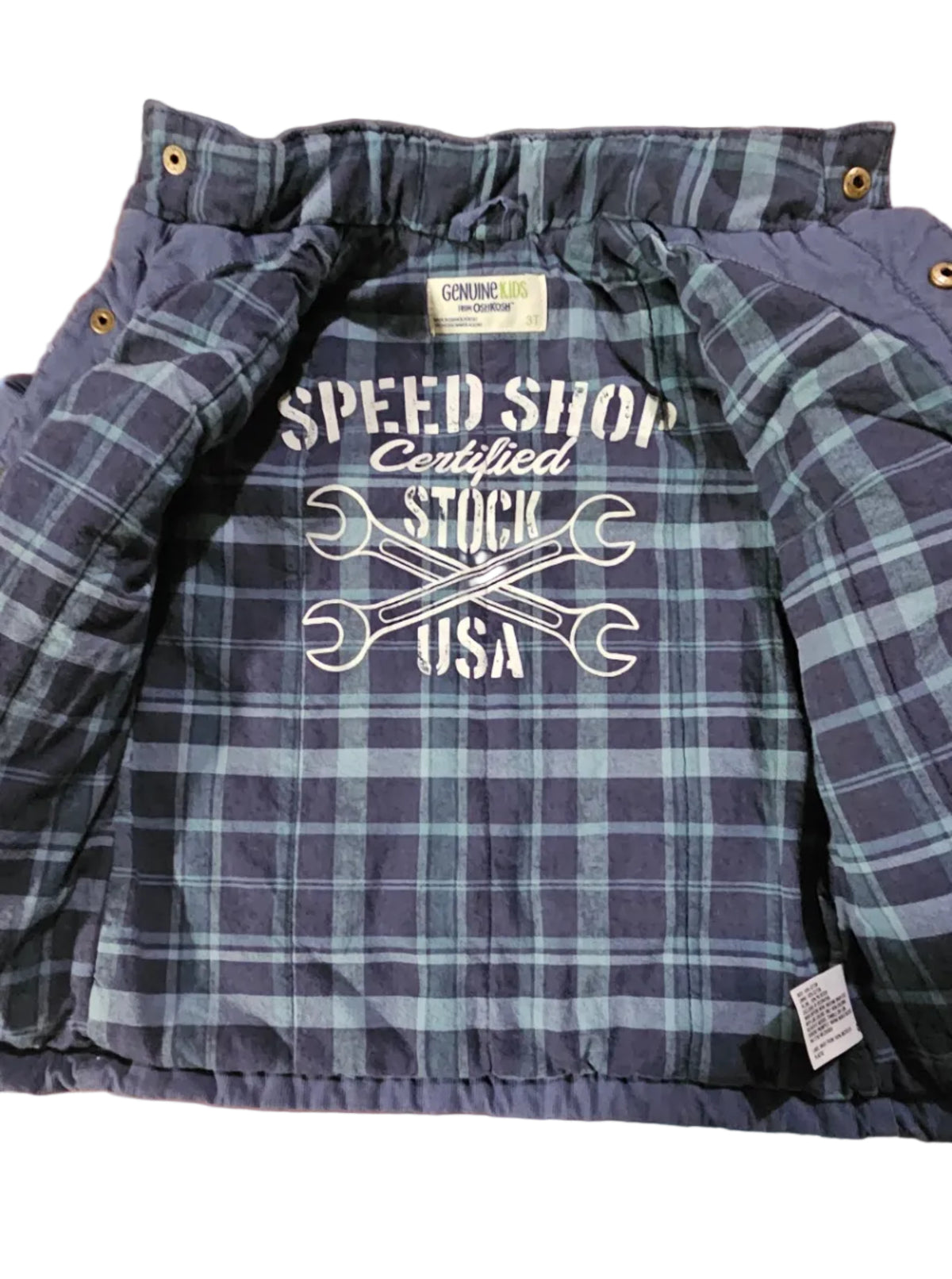 Plaid lining inside OshKosh jacket with Speed Shop crossed-wrench graphic