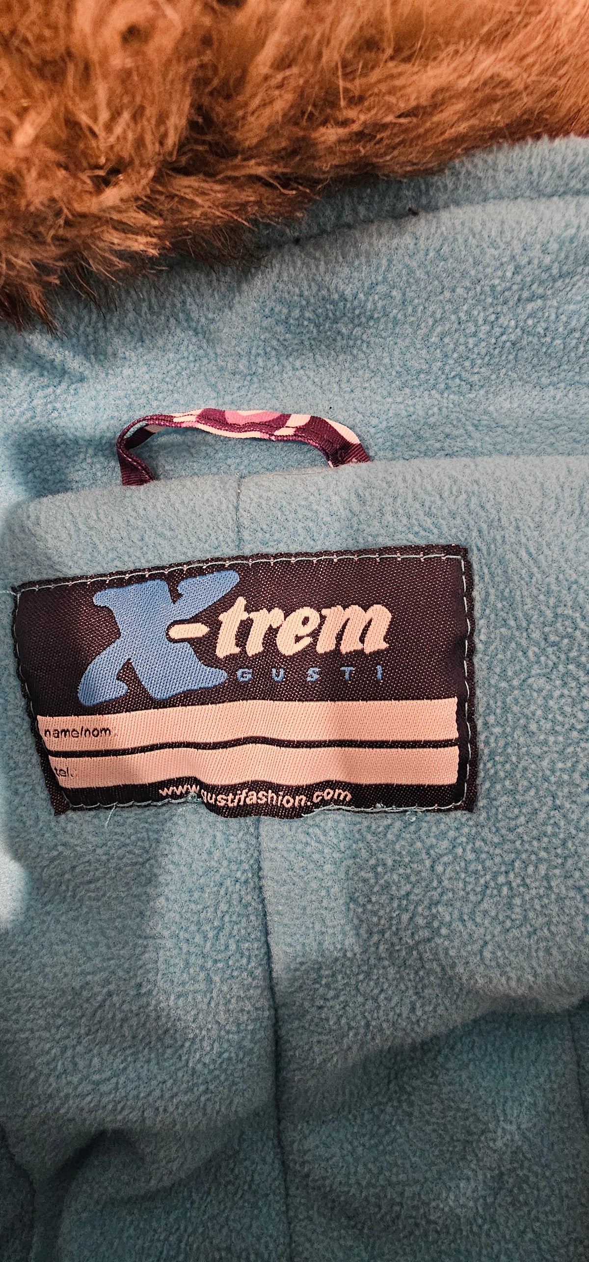 Gusti X-trem brand label and turquoise fleece lining