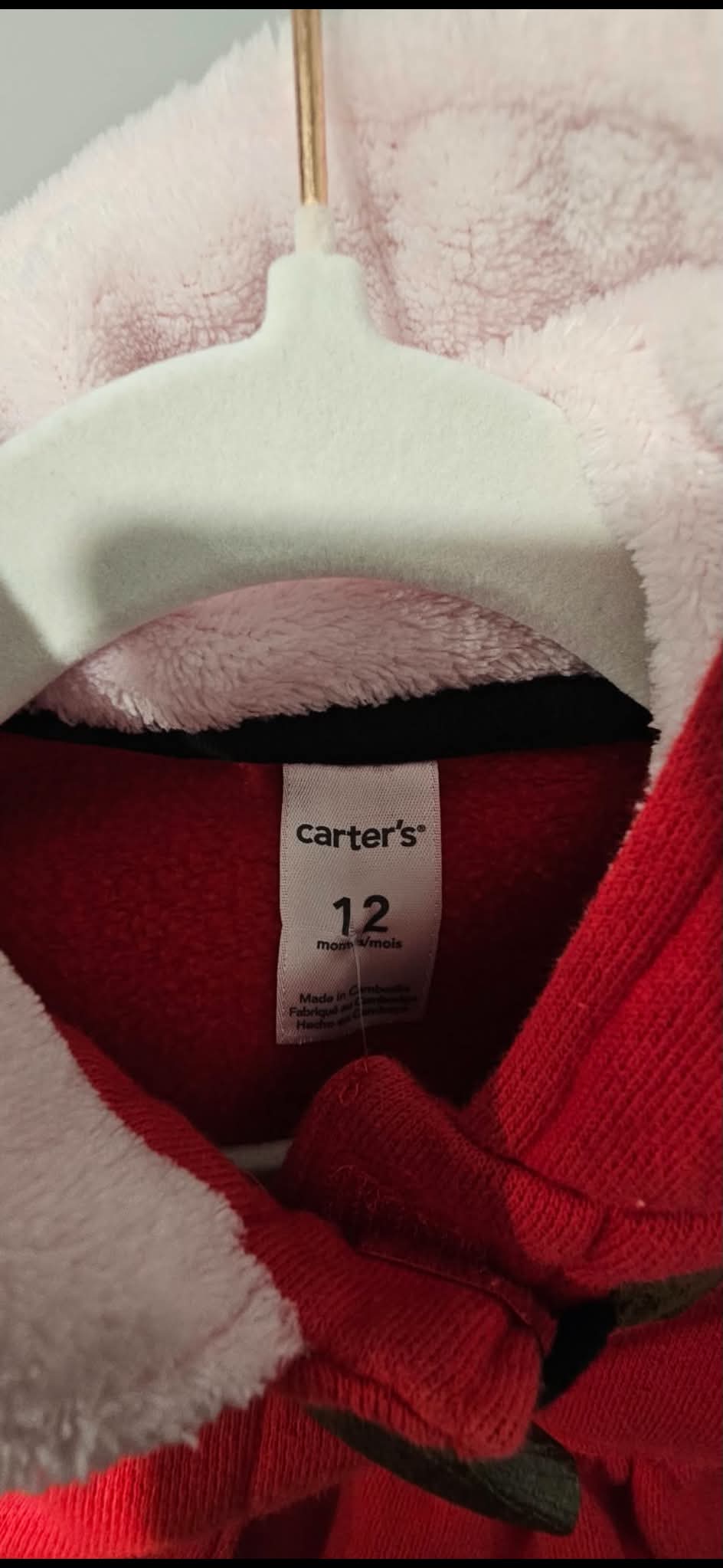Carter’s 12 months size label and pale pink plush hood lining