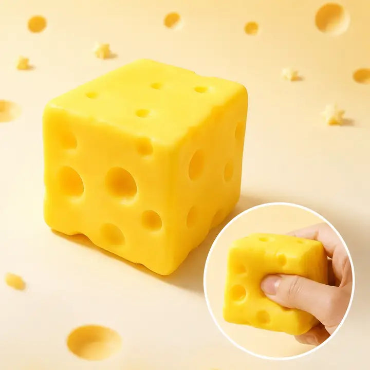 Yellow cheese-cube squeeze toy with cheese-hole detailing and inset showing it squeezed by hand