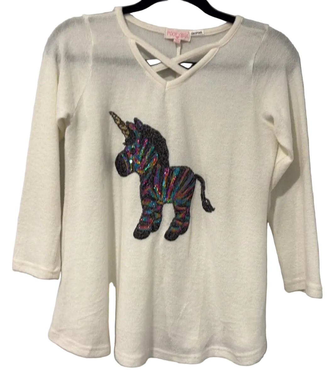 Front of cream Poof Girl unicorn top with crisscross neckline