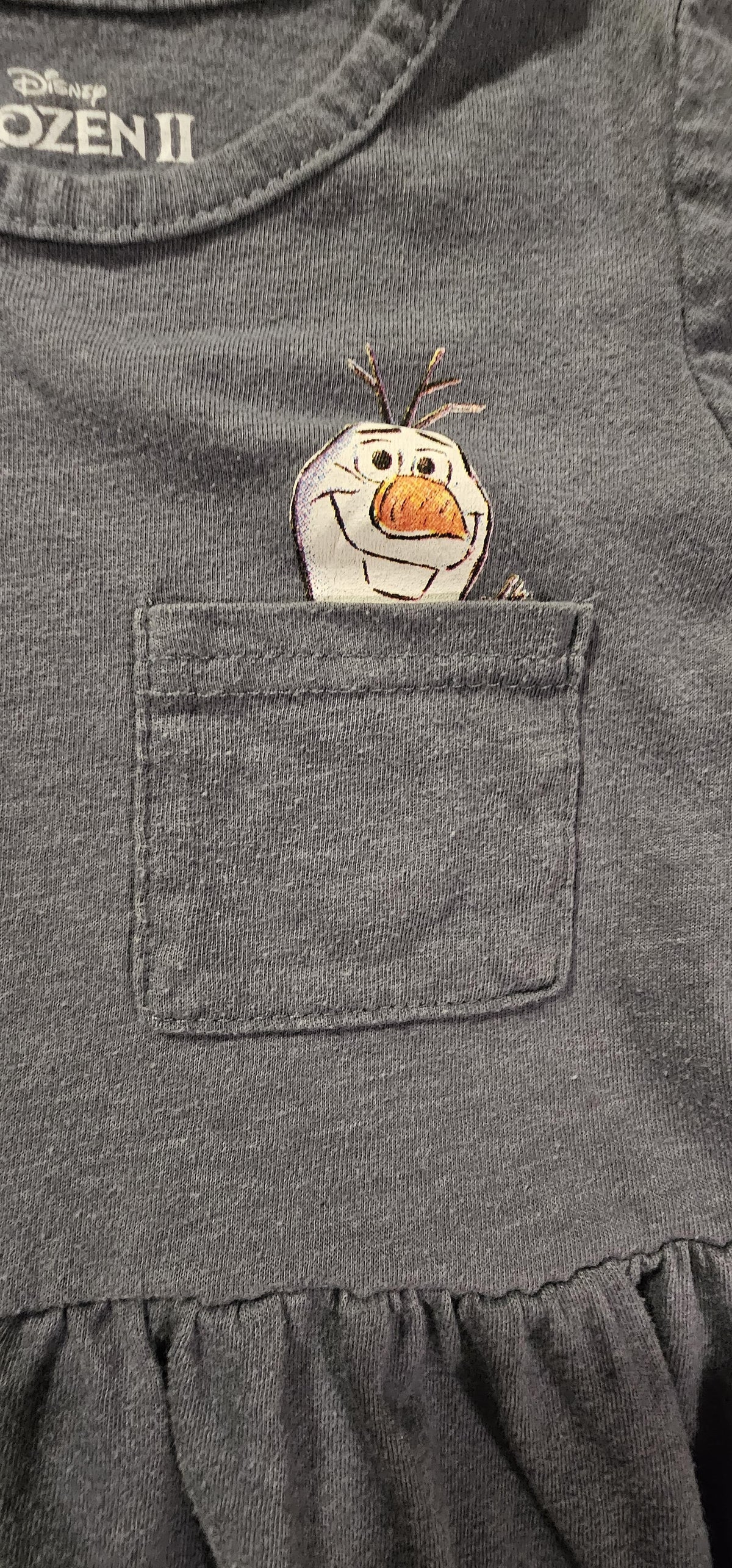 Olaf peeking from the chest pocket, close-up