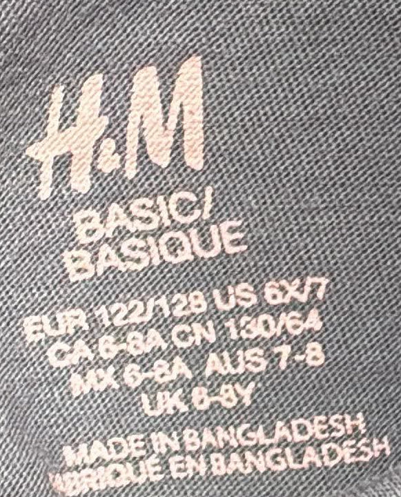 H&M size label showing EUR 122/128, US 6X/7 and UK 6–8Y