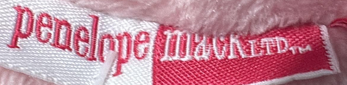 Penelope Mack brand label and pink plush lining